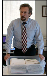 Von Holt standing at his desk
